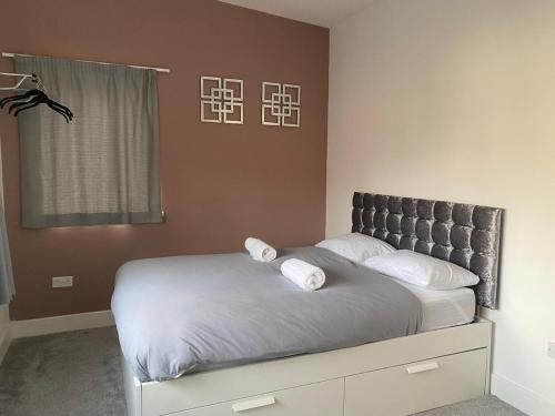 a bedroom with a bed with two pillows on it at Newcastle City Penthouse in Newcastle upon Tyne