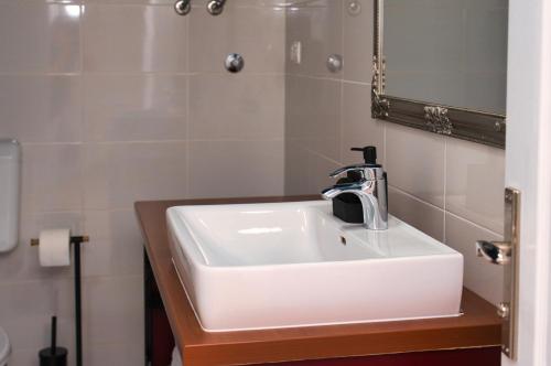 a bathroom with a white sink and a mirror at Central Beach Retreat in Trogir