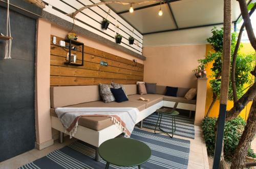a patio with a bed and a couch at Central Beach Retreat in Trogir