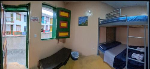 a room with two bunk beds and a window at Hospedaje Hermanos Cardona in Armenia