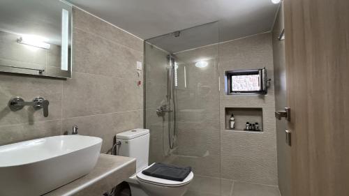 a bathroom with a shower and a toilet and a sink at Tago Houses in Elafonisos