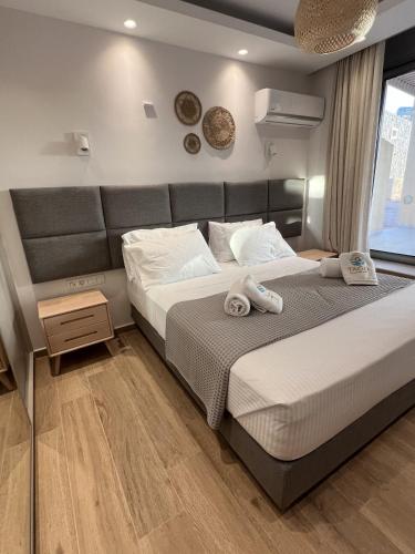 a bedroom with a large bed and a window at Tago Houses in Elafonisos