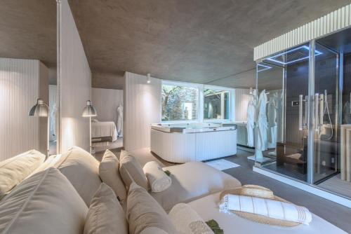 a large living room with a couch and a tub at Casa do Rio - Douro Wine Hotel by Vallado in Vila Nova de Foz Coa