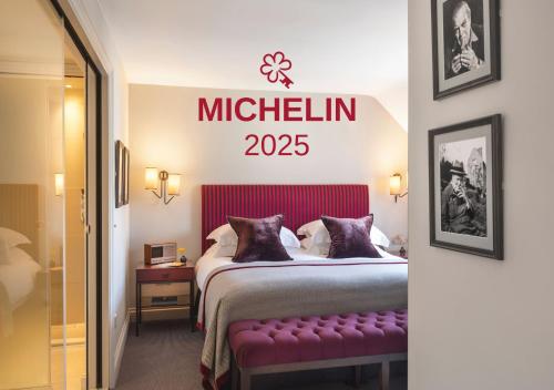 a hotel room with a bed and a sign on the wall at Old Parsonage Hotel in Oxford