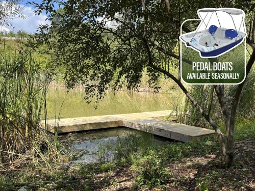 a sign for a pond with a boat on it at The Lodges at Eden Reserve - Cabins Near Ark in Williamstown