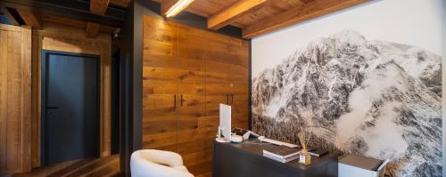 a living room with a picture of a mountain on the wall at Chambre d'Hotes Vista Monte Bianco in La Salle