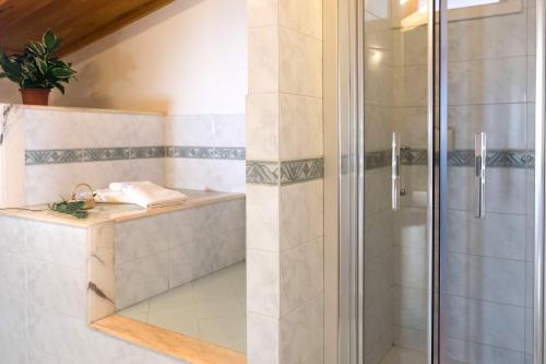 a shower with a glass door in a bathroom at B&B L'Approdo in Piano di Sorrento