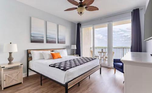 a bedroom with a bed and a balcony at Blue Heron Resort in Orlando