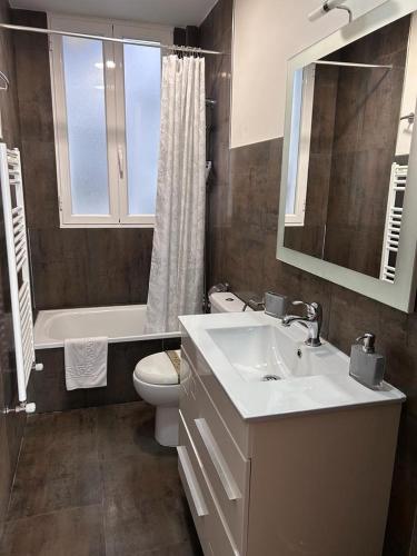a bathroom with a sink and a toilet and a tub at Los Soportales in Soria