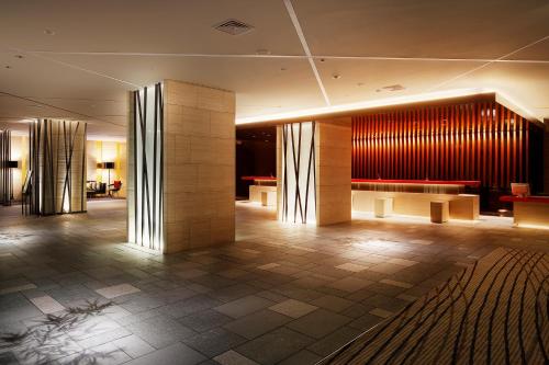 a lobby of a hotel with wooden walls and tables at RIHGA Royal Hotel Kyoto in Kyoto