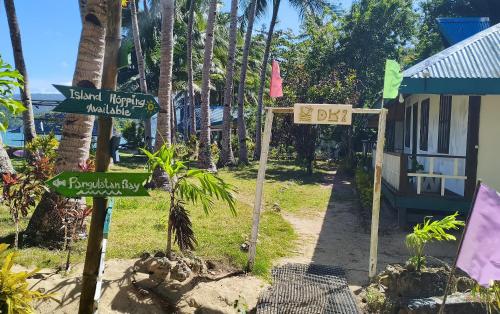 a street sign in front of a house at DK2 Resort - Remote Beach Hideaway - Fast WiFi - Private Tours by Arrangement - Plan Ahead in El Nido