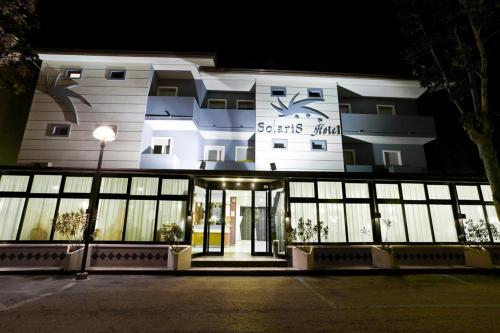 a building with the entrance to a hotel at night at Hotel Solaris in Gatteo a Mare