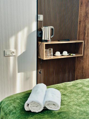 a room with two towels sitting on a bed at City Star Kutaisi in Kutaisi