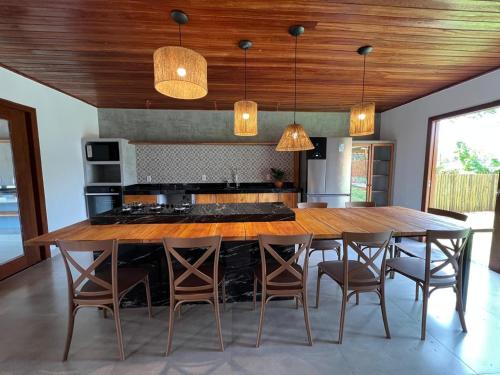 a kitchen with a large wooden table and chairs at Casa Canto do Bem-te-vi in Lençóis