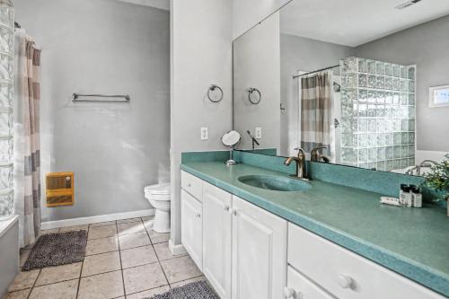 a bathroom with a sink and a toilet at Harbor Island 49 Nautical Watch in Fripp Island