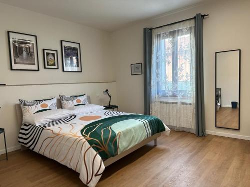 a bedroom with a bed and a large window at B&b DALLA FE in Fermignano