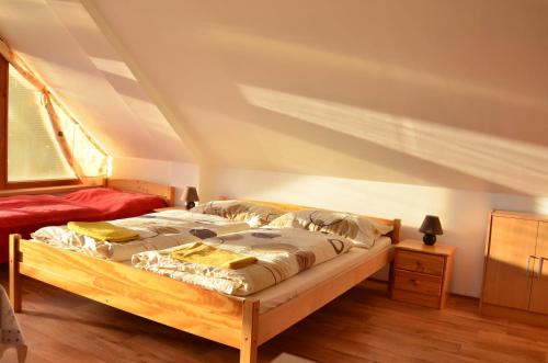 a bedroom with two beds in a attic at ubytování MILUMI in Strážnice