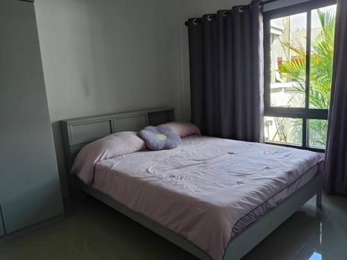 a bed with two stuffed animals on it in a bedroom at Sea heaven Phuket Naiyang in Phuket