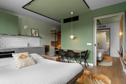 a bedroom with a bed and a dining room at Corendon Urban Amsterdam Schiphol Airport Hotel in Badhoevedorp