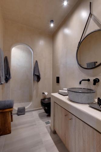 a bathroom with a sink and a mirror at Areos Luxury Suites in Vóthon