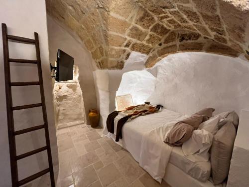 a bedroom with a bed with a book on it at LA SEGRETA DEL CASTELLO, Private Access in Gioia del Colle