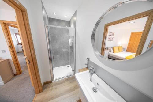 a bathroom with a sink and a mirror at Ben View Room 3 in Fort William
