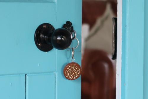 a pair of black door knobs on a blue door at The Biscuit Box Ideal For Couples Or Families in Low Hesket