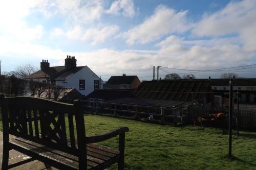 a bench sitting in the grass in a yard at The Biscuit Box Ideal For Couples Or Families in Low Hesket