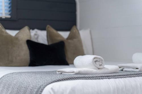 a bed with two towels and pillows on it at Apex Studio Pod and Jacuzzi Bath in Fort William