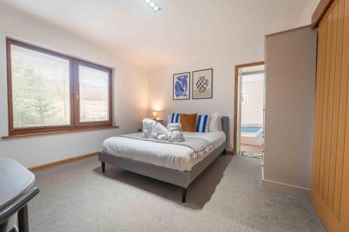 a bedroom with a bed and a window at Ben View Room and Jacuzzi Bath in Fort William