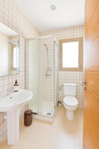 a bathroom with a toilet and a sink and a shower at Can Angelica in Santa Margalida