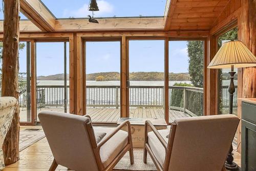 a living room with two chairs and a large window at Candlewood Isle in New Fairfield