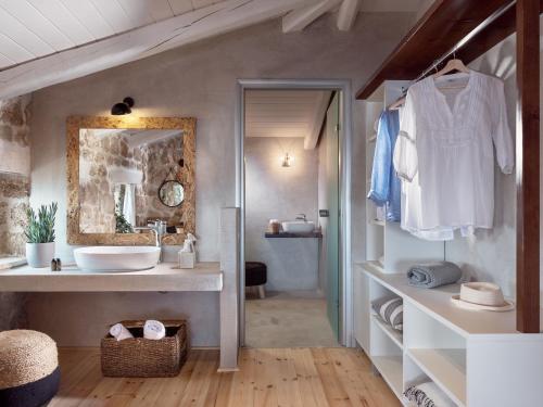 a bathroom with a sink and a mirror at Astarte Villas - Arismari Villas in Vasilikos