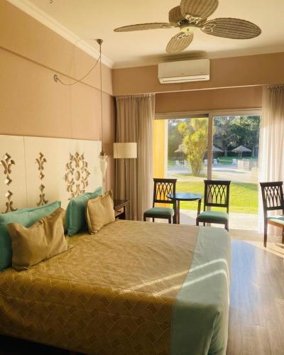 a bedroom with a bed and a table and chairs at Howard Johnson Pilar Resort Spa & Convention Center in Pilar