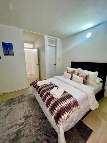 a large bedroom with a large bed in a room at Casa del Prado in Santa Marta