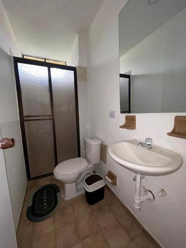 a bathroom with a toilet and a sink at Casa del Prado in Santa Marta