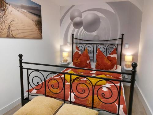 a bedroom with a bed with a wrought iron headboard at Gemütliches Feriendomizil in Niederorschel