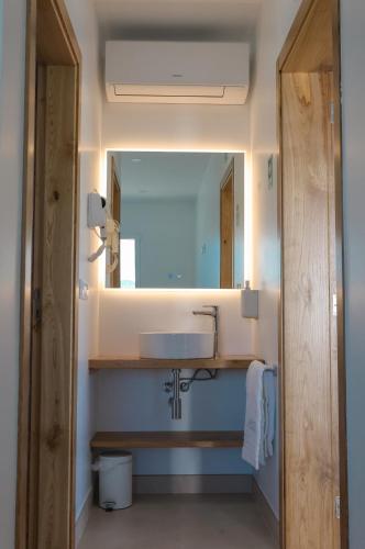 a bathroom with a sink and a mirror at Casa do Santo Estevão in Macedo de Cavaleiros