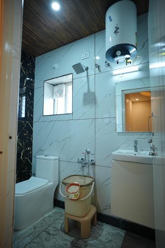 a bathroom with a toilet and a sink at SN Comforts in Bangalore