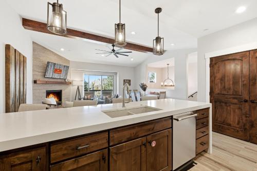 a kitchen with a sink and a living room at Snowline at Black Rock Ridge in Kamas