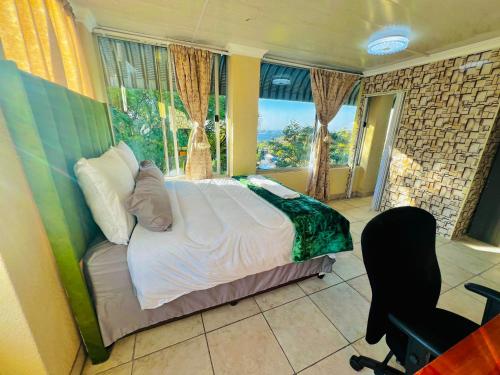 a bedroom with a bed and a chair and a window at Honeyhills Excellence Resort E in Roodepoort
