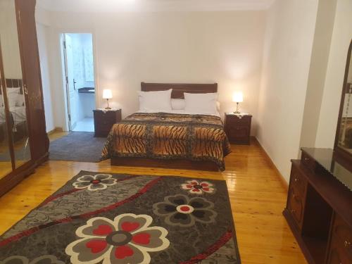 a bedroom with a bed and a rug at سي فيو سان ستفانو in Alexandria