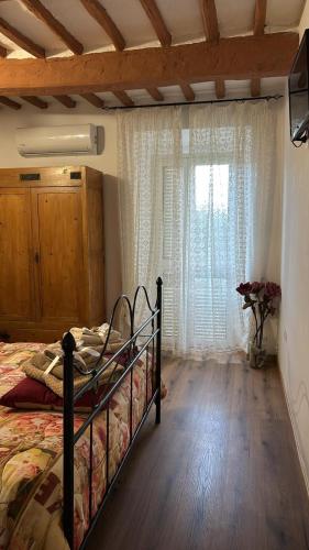 a bedroom with a bed and a large window at Casa di Mario in Graffignano