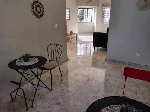 a living room with a table and chairs at Double bed room in Santo Domingo