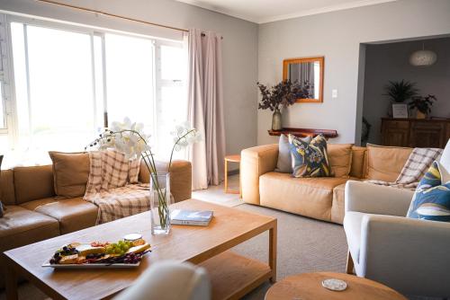 a living room with a couch and a table at LazyYzer in Yzerfontein