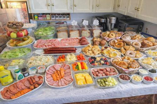a table filled with lots of different types of food at Cozy Nook in Fraser Valley Getaway with Breakfast in Abbotsford