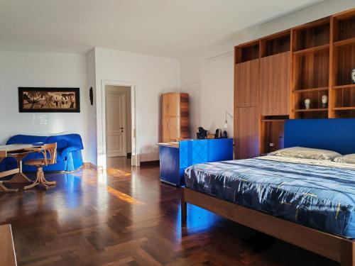 a bedroom with a blue bed and a table at Blue emotion, into wellness & wilderness in Albano Laziale