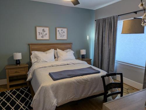 a bedroom with a bed and a table and a window at Casa 131 in Tucson