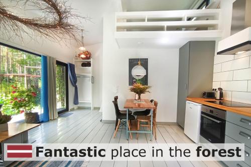 a kitchen with a table and a kitchen with the text fantastic place in the forest at Rabarberi LV just 15min walk to SeaSide in Saulkrasti