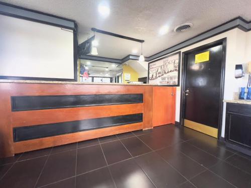 a fast food restaurant with a counter and a door at Economy Suites Fairgrounds in Tulsa